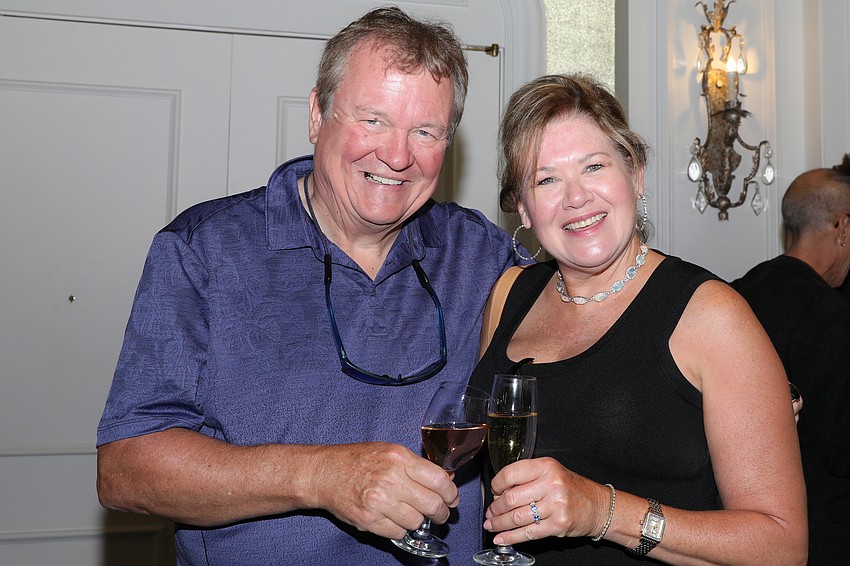 Tim and Trish McDonald toast to the Humane Society efforts at the Mission Pawssible fundraiser luncheon.