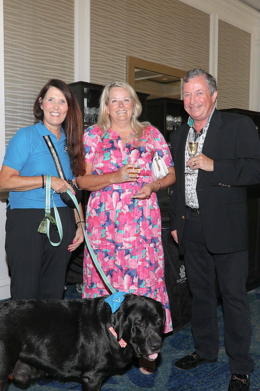 Maureen Rogers, Amy Wenzel, Ian Wilbraham and Sid the black Lab rescue.
