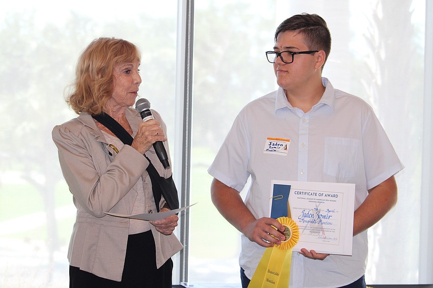 Jaden Zomir accepts his award from judge Sandy Moulin.