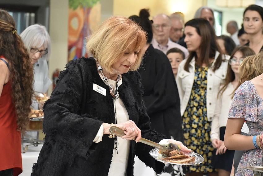 Margie Barrie gathers some food.