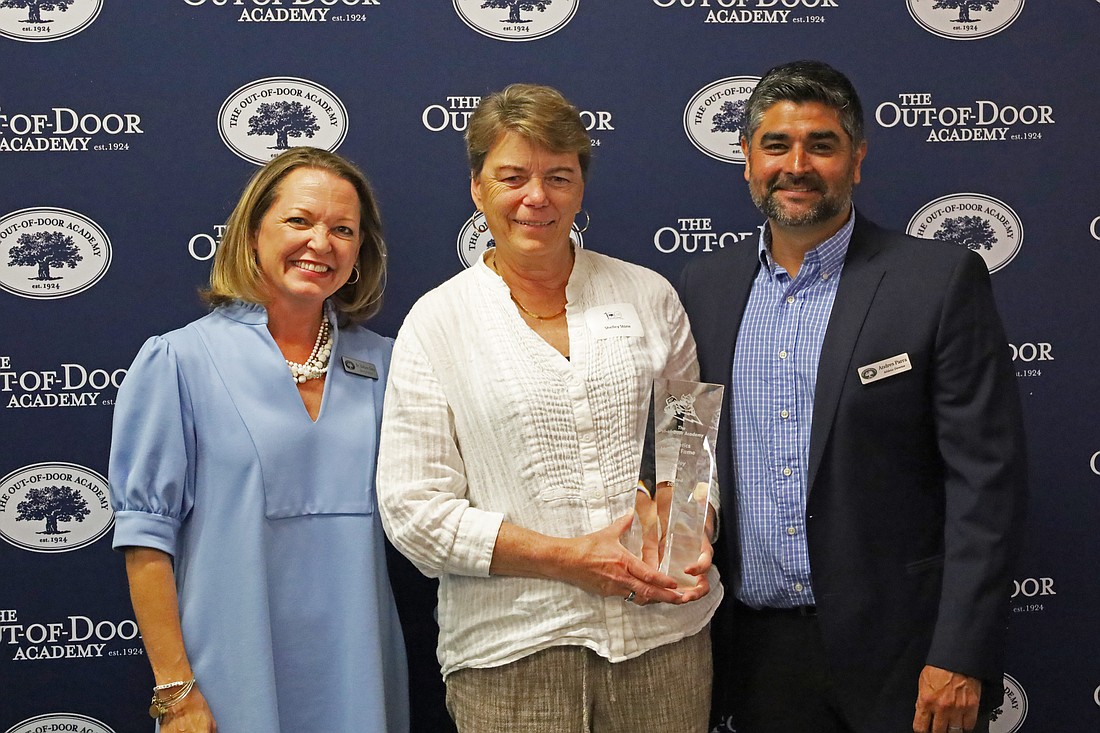 Shelley Stone (center) accepts her ODA Athletics Hall of Fame award alongside Head of School Debra Otey and current Athletic Director Andres Parra on April 10.
