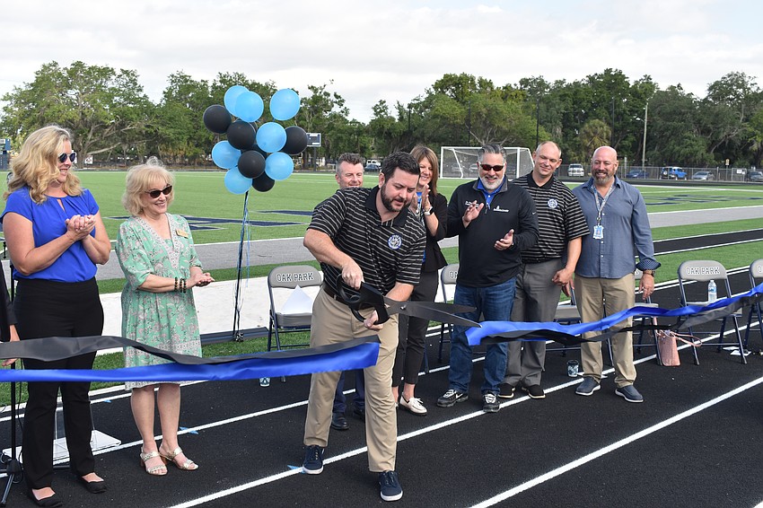 Principal Sean Donovan cuts the ribbon.