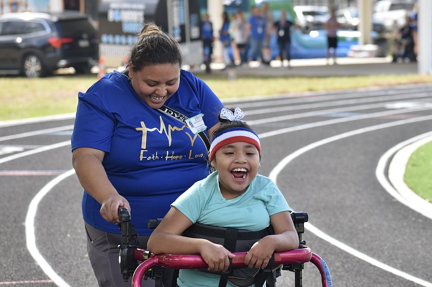 Ingrid Rodriguez walks with her daughter Valentina Rodriguez, a second grader, on the track.