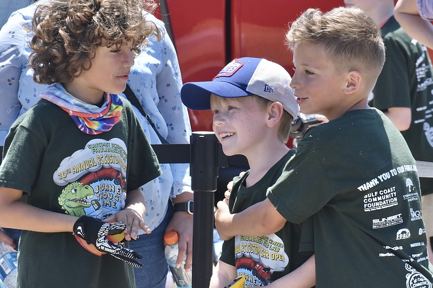 Ethan Nicolau, Aidan English and Jacob Light celebrate their victory in the race.