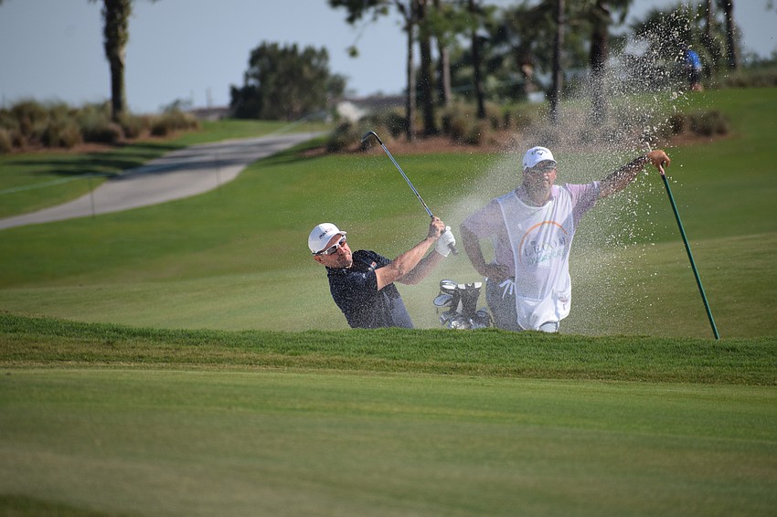 Julian Etulain hits out of the greenside bunker on No, 14 at Lakewood National during the first round of the LECOM Suncoast Classic Wednesday. Etulain finished at even-par 71.