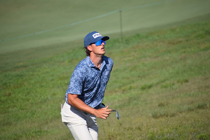 Gavin Cohen races up a hill to see where his chip shot landed on No. 11 at Lakewood National Golf Club. Cohen finished at 5-under 66.