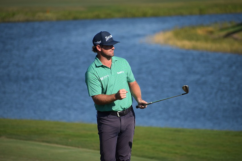 Wilson Furr pumps his fist after his chip settled next to the hole on No. 11 at Lakewood National. Furr finished at 2-under 69.