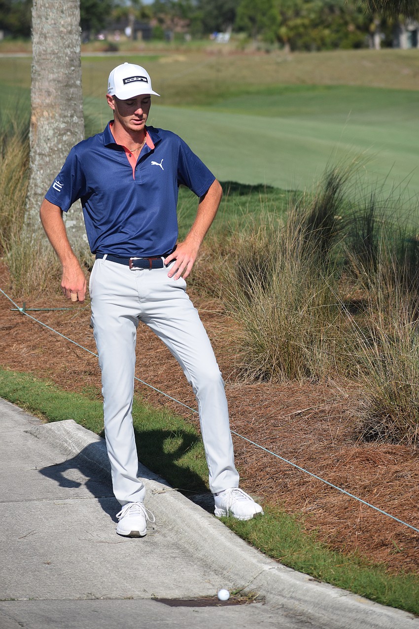 Nick Gabrelcik waits for a course official to figure out how he is going to take relief from the cart path during Thursday's second round of the LECOM Suncoast Classic at Lakewood National.