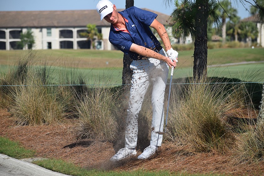 Nick Gabrelcik punches out of the pine straw after taking relief from the golf cart path on No. 11 Thursday at Lakewood National. Gabrelcik is tied for 37th at 6-under-par.