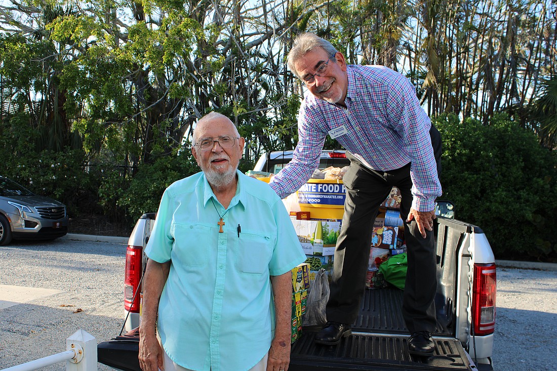 Stillpoint Mission past president Gene Tischer and current president Gary Scott pick up donations from Longboat Island Chapel for this month's Gather and Give drive.
