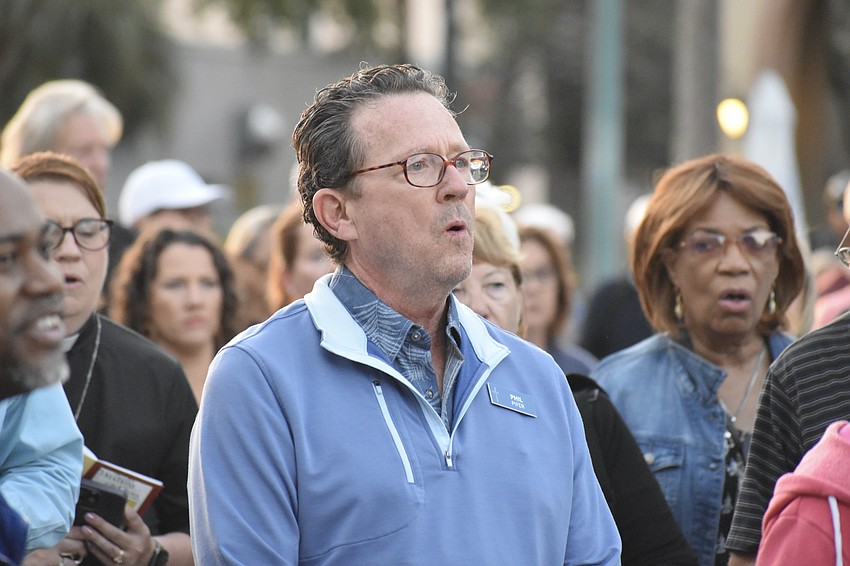Phillip Pifer sings with the crowd during a song.
