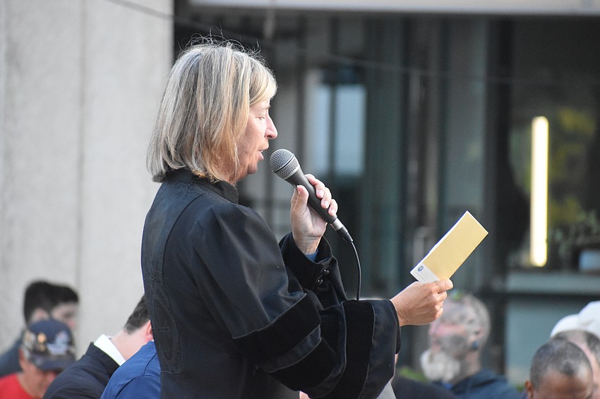 Senior Pastor Ruth Smalt of Siesta Key Chapel speaks at the third station.