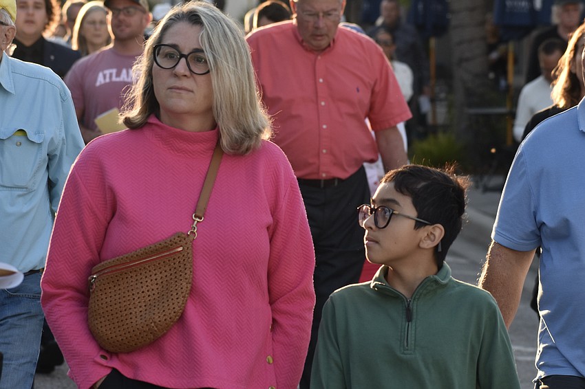 Tiffany Echols and her son Oscar Echols, 11, walk together. As Church of the Redeemer members, it was their first time participating in the walk, after moving to Sarasota from Alabama. 