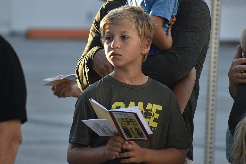 David Lindenau, 10, listens a speaker while stopped at one of the stations.