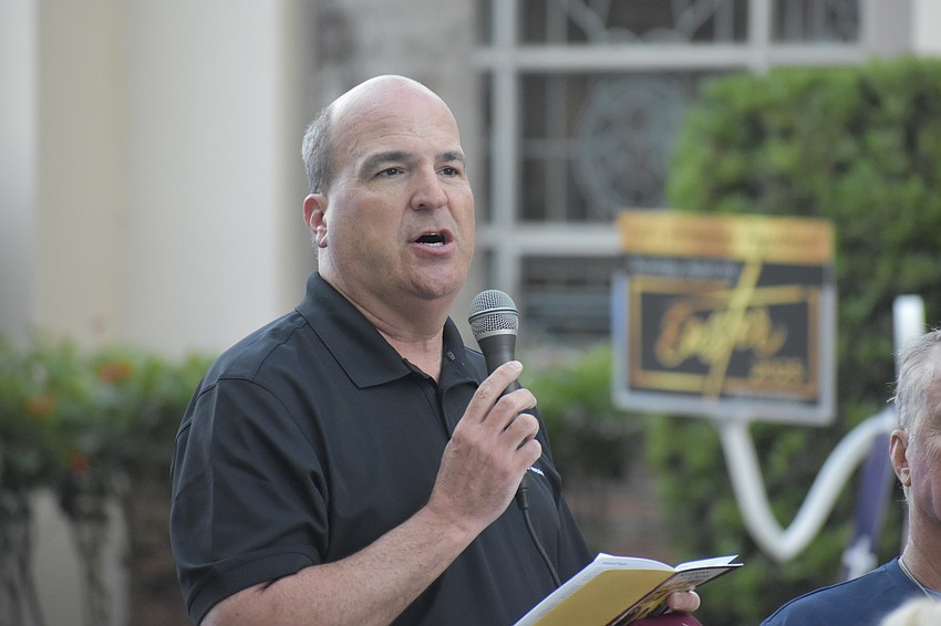 Senior Pastor Brett DeHart of First United Methodist Church speaks at the 11th station, in front of the church.