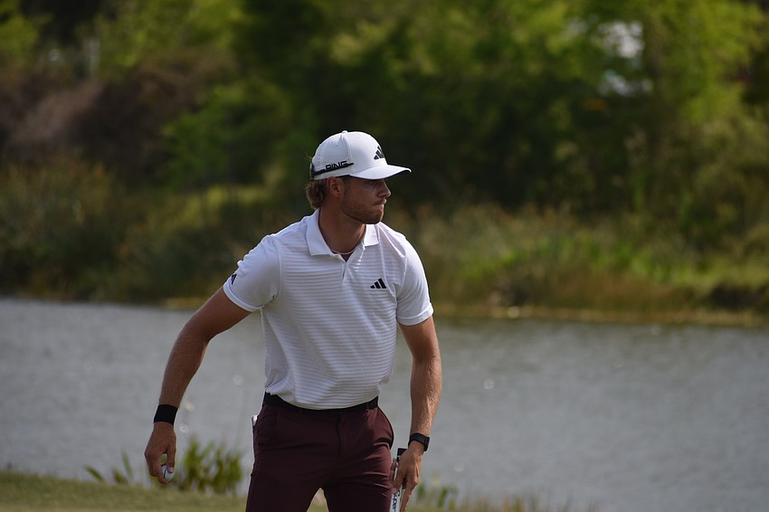 Chase Sienkiewicz pauses to consider throwing his ball in the water after missing a par putt on No. 14 during the third round of the LECOM Suncoast Classic.