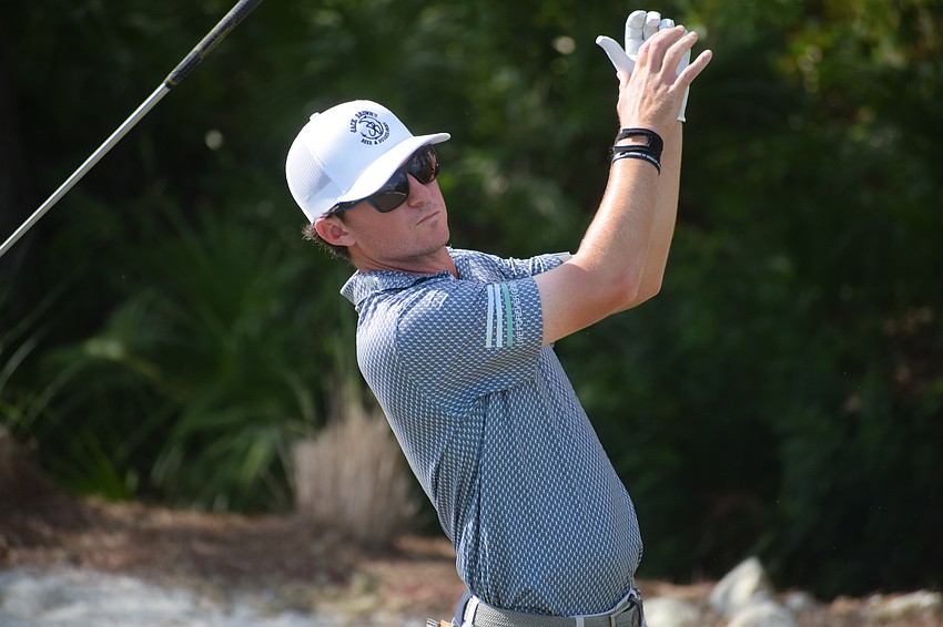 Michael Johnson lets his club fly after hitting an unsatisfactory shot on the par-3 No. 15. Johnson shot a three-under 68 on Friday to put himself in a tie for first place at 15-under-par.