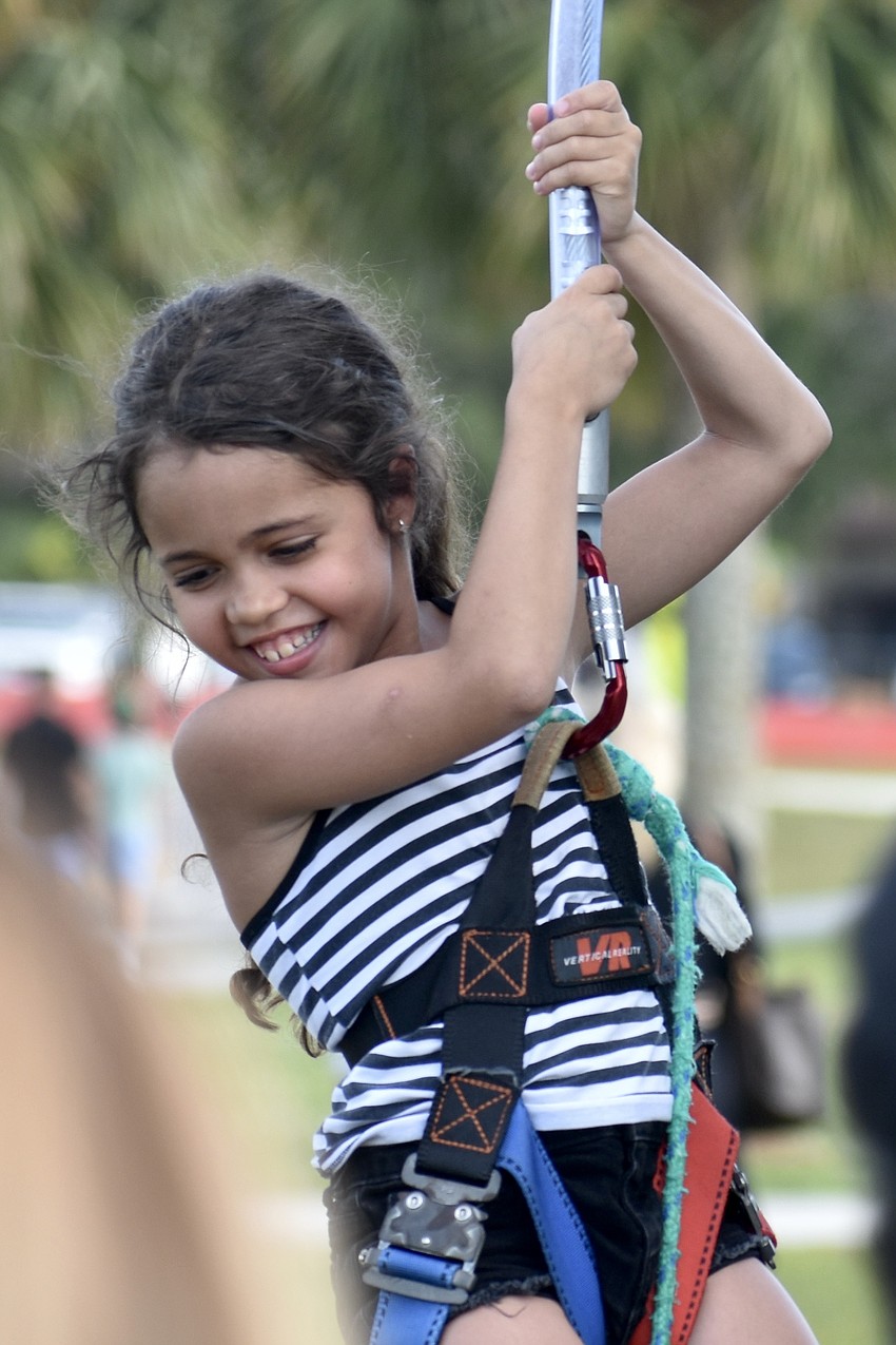Paris Gousman, 9, descends from a session of rock climbing.
