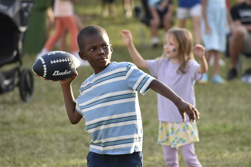 Jamarion Johnson, 7, tosses a football.