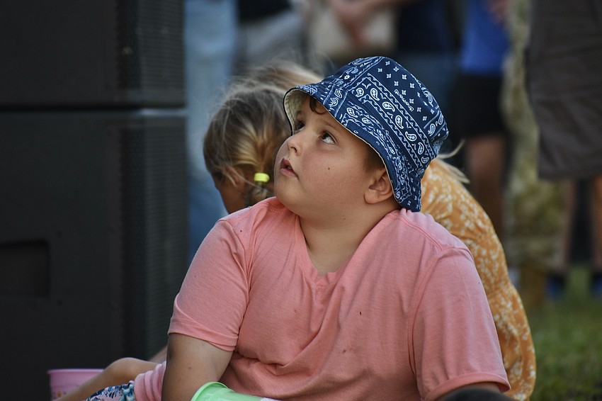 Levi Smith, 6, sitting at the foot of the stage, looks up as Tim Tebow speaks.