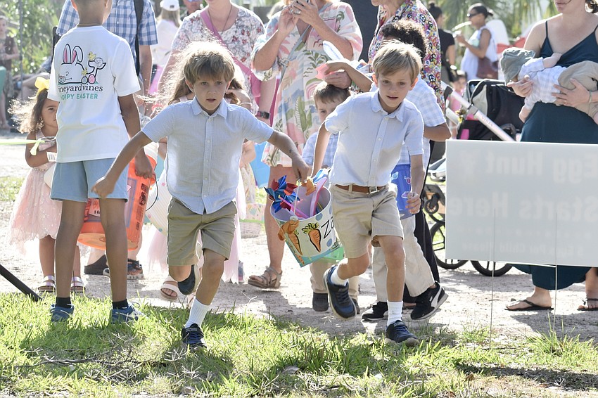Zachary Perez, 6, and his brother Nate Perez, 8, start out on the egg hunt.