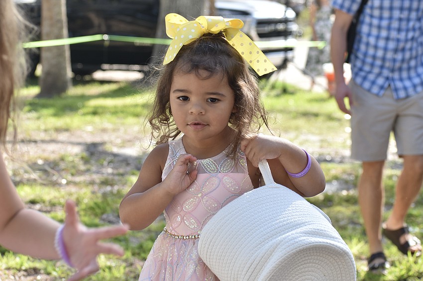 Myla Green, 3, searches for eggs.