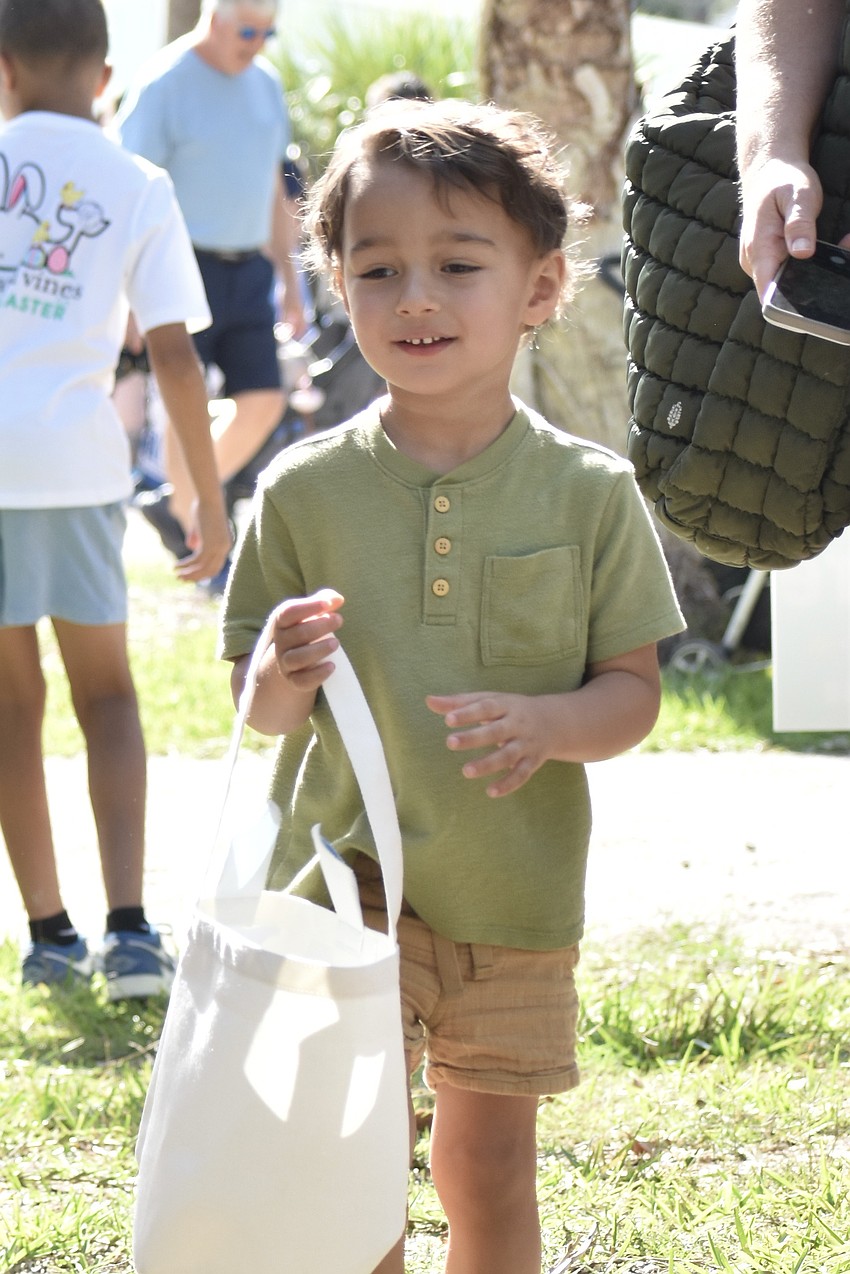 Noa Seidell, 3, looks for Easter eggs.