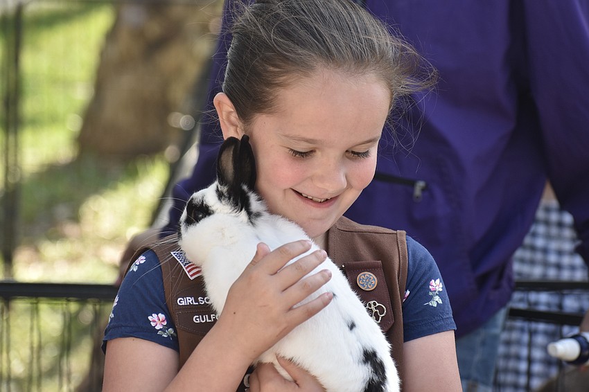 Penelope McCauley, 8, a Girl Scouts brownie, holds a bunny.