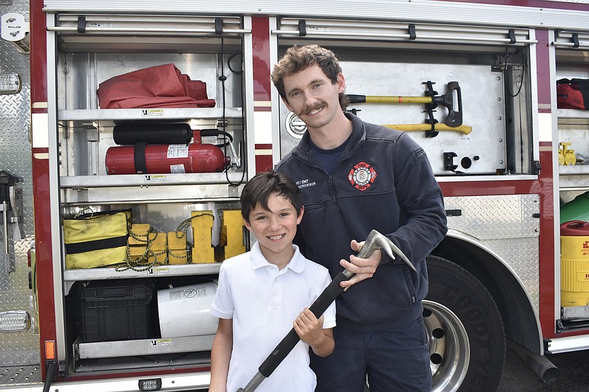 Bradley Wade, 8, meets Mikey Hendrickson, a firefighter and EMT with Station 13 in Siesta Key.