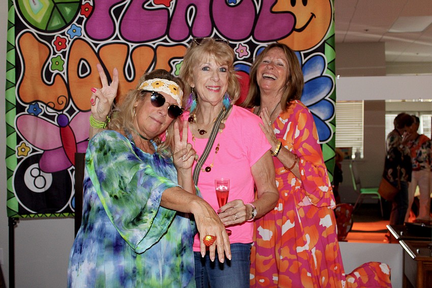 Sandi Love shows off her glowing bling with Angela Bennink and Debby Debile.