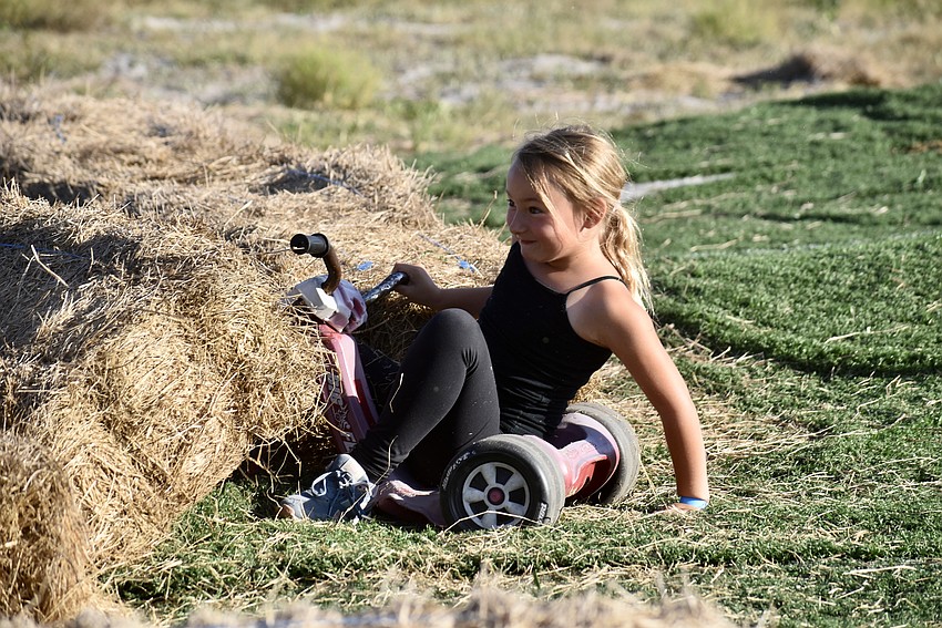 Bales of hay stop 7-year-old Olivia Johnson at the bottom of the hill.