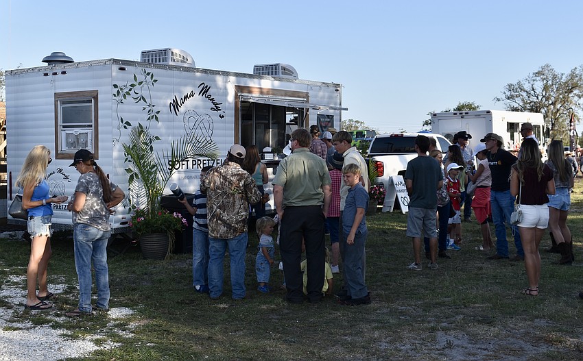 Food trucks and vendors set up outside of the arena.