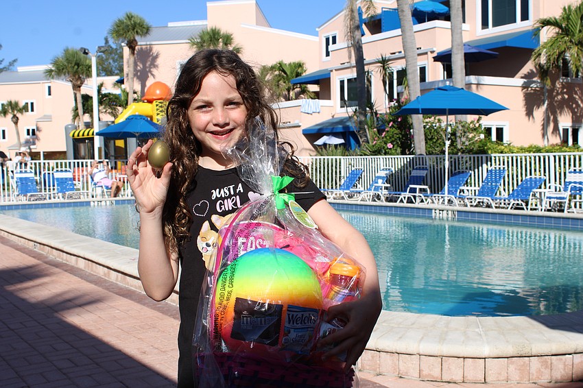 Lilly Matney, 8, found one of the golden eggs at Sand Cay's Easter egg hunt this year.