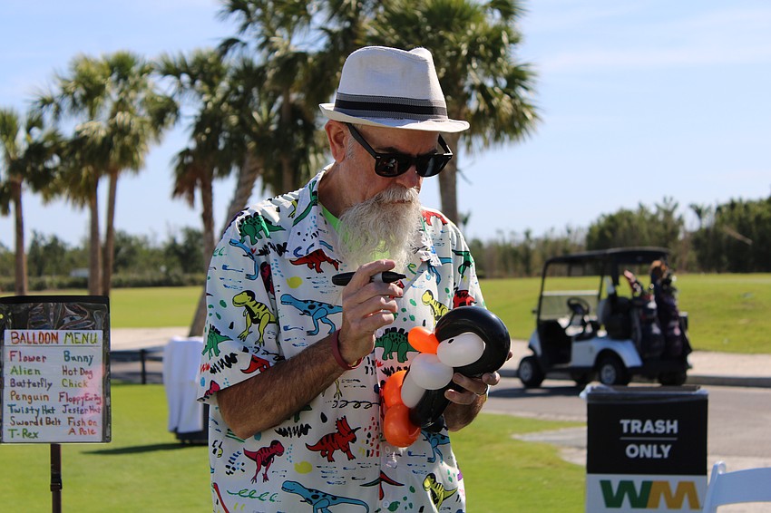 Steve Finsted puts the finishing touches on a balloon penguin at Longboat Key Club Resort.