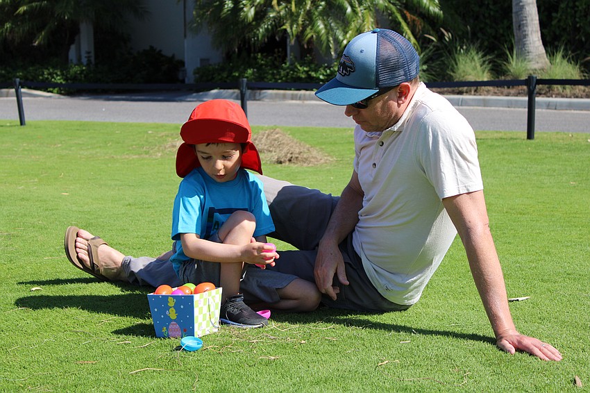 Mica, 4, and Pete Wagner inspect the treats he found at the Longboat Key Club Resort egg hunt. Mica said his favorite Easter candy is licorice.