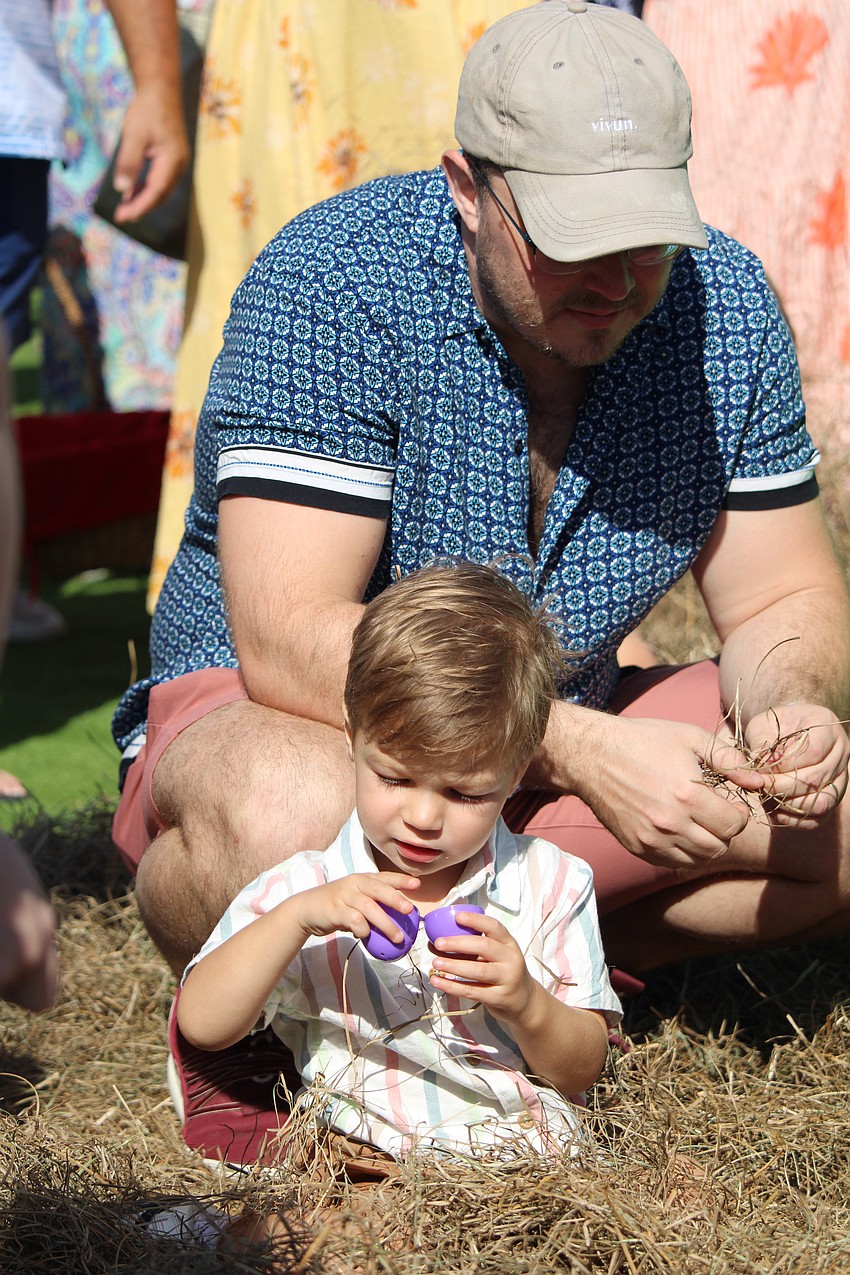 2-year-old Aiden Jendelund checks out a purple Easter egg.
