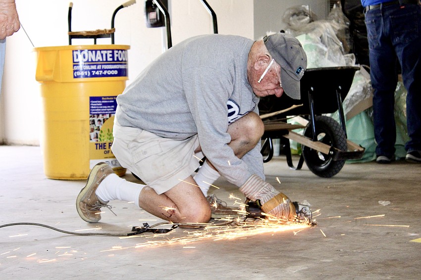 Sparks were flying as volunteer Tom Morse made sure any stuck nails from the pews were ground away.