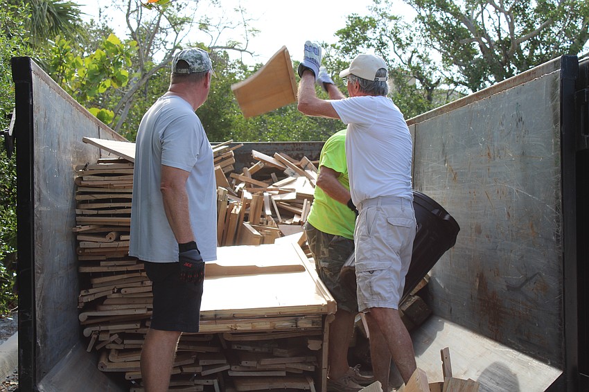 Volunteers bid farewell to the final pieces of the outgoing pews.