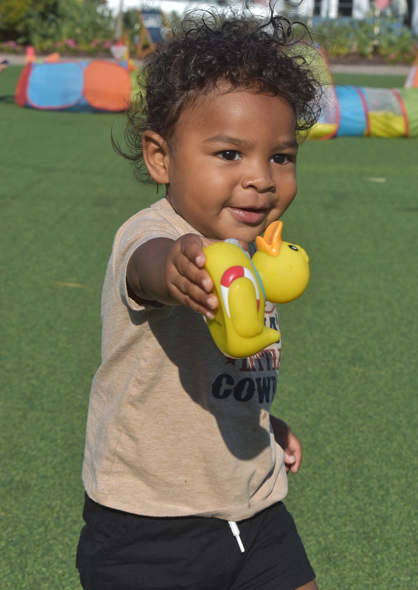 Lakewood Ranch 1-year-old Ezra DuBose puts the squeeze on a rubber duck at the UTC Kids Club Wednesday.