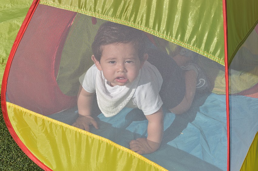 Lakewood Ranch 1-year-old Lucca Benavides made sure his mother, Camila Duenas, was keeping an eye on him at UTC Kids Club.