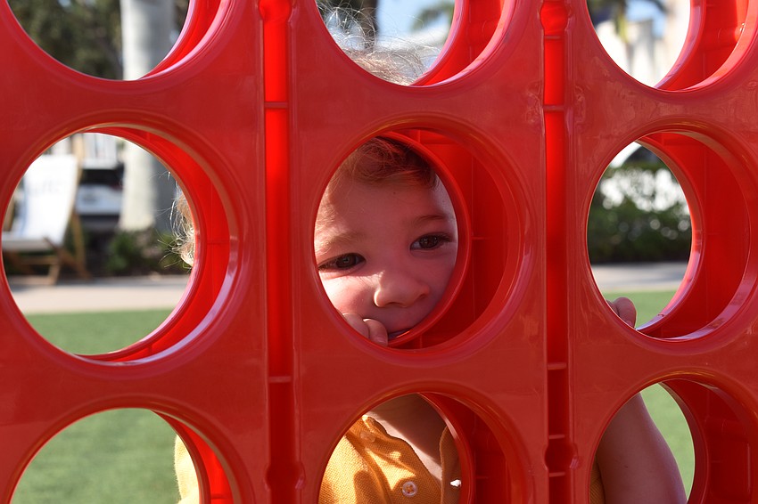 Parrish 2-year-old Faris Akel decided to look through the holes of the giant Connect 4 game instead of playing the traditional way at UTC Kids Club Wednesday.