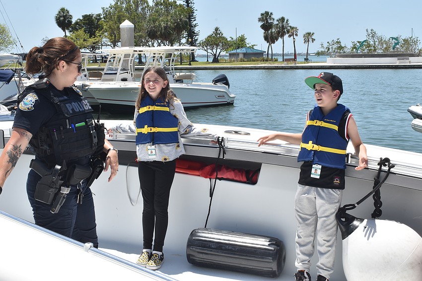 Officer Jade Fukanaka speaks with Kameron Ennis, 10 and Beau Petrilla, 10.