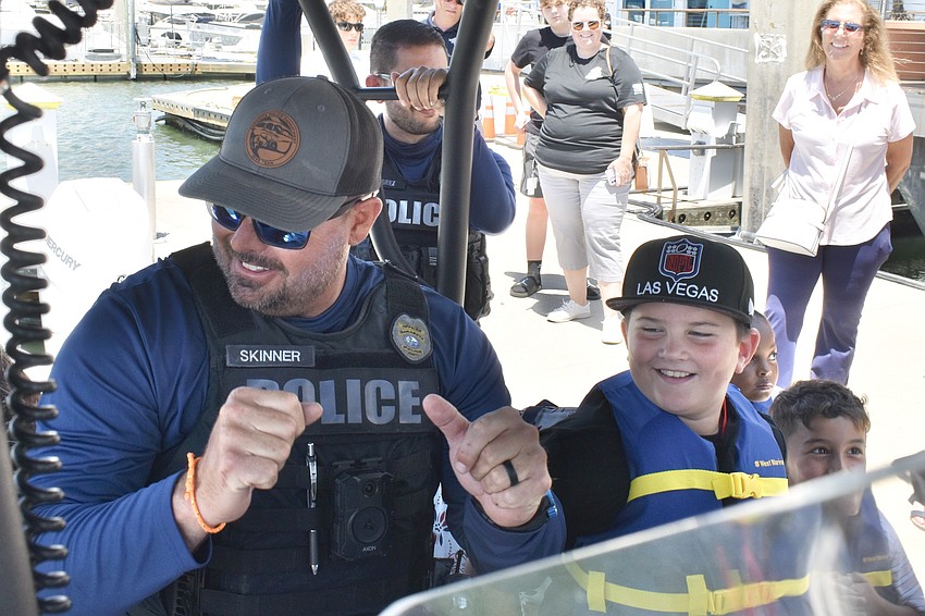 Marine Patrol Officer Michael Skinner starts a dance party with Captain Harvey, 9.