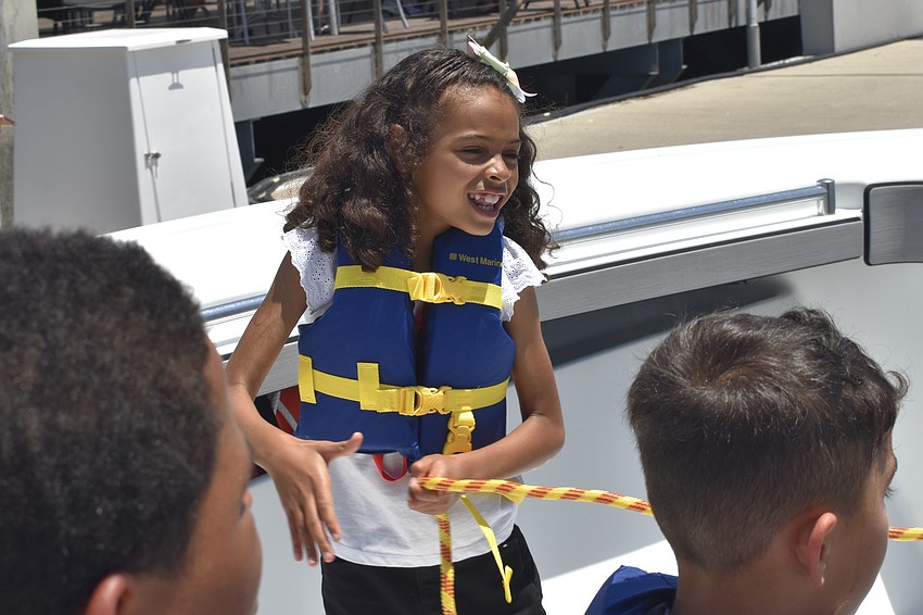 Analise Gallant, 7, reels in a rescue bag.
