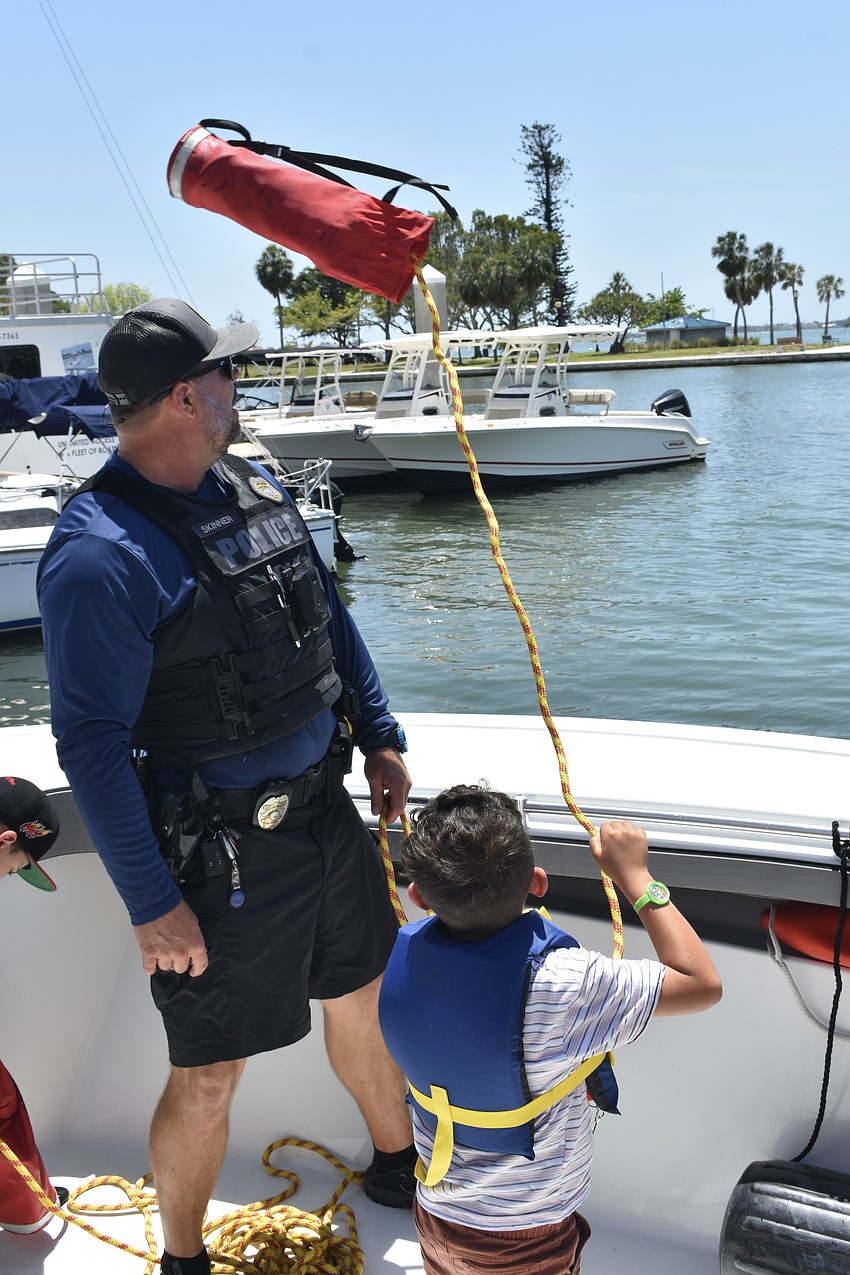 EJ Jimenez, 7, tosses out a rescue bag.