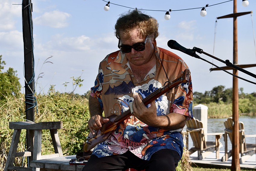 Blues musician Steve Arvey plays a guitar made from a canoe paddle.