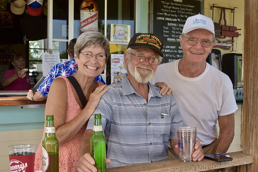 Braden Woods' Sue and Ron Clark enjoy the music with Bradenton's Steve Moore.