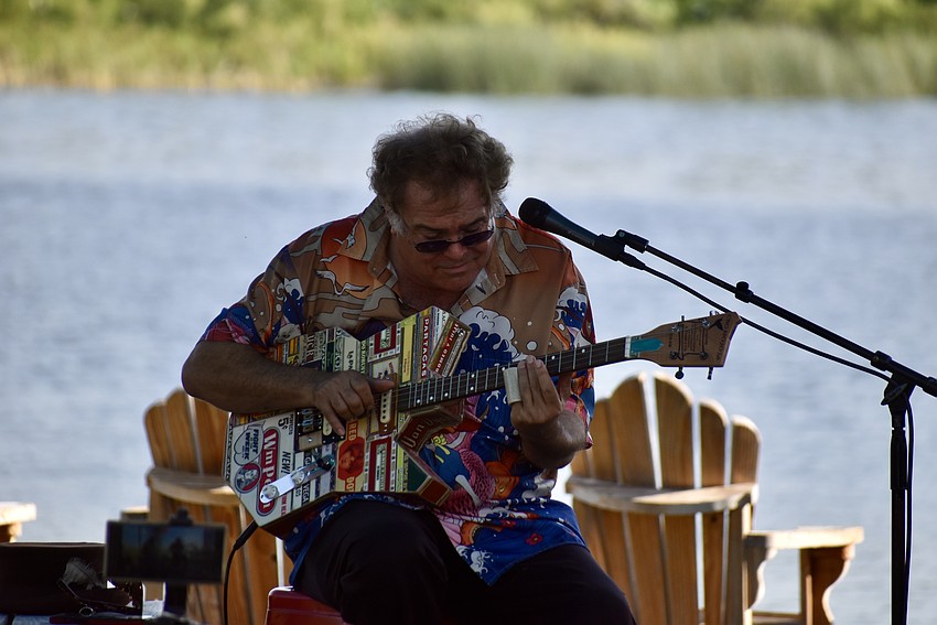 Steve Arvey plays a cigar box guitar.