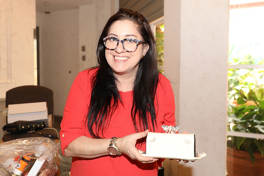 Chantalle Soganich with a butter dish made by local potter Sarah Hans and donated to the silent auction.