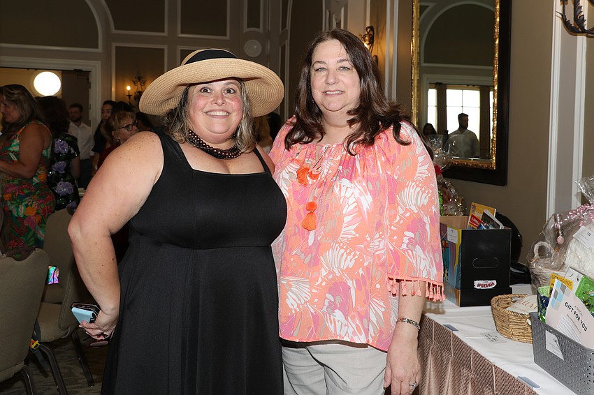 Carey Gerardi and Lisa Comeau enjoy the wide selection of silent auction donations.